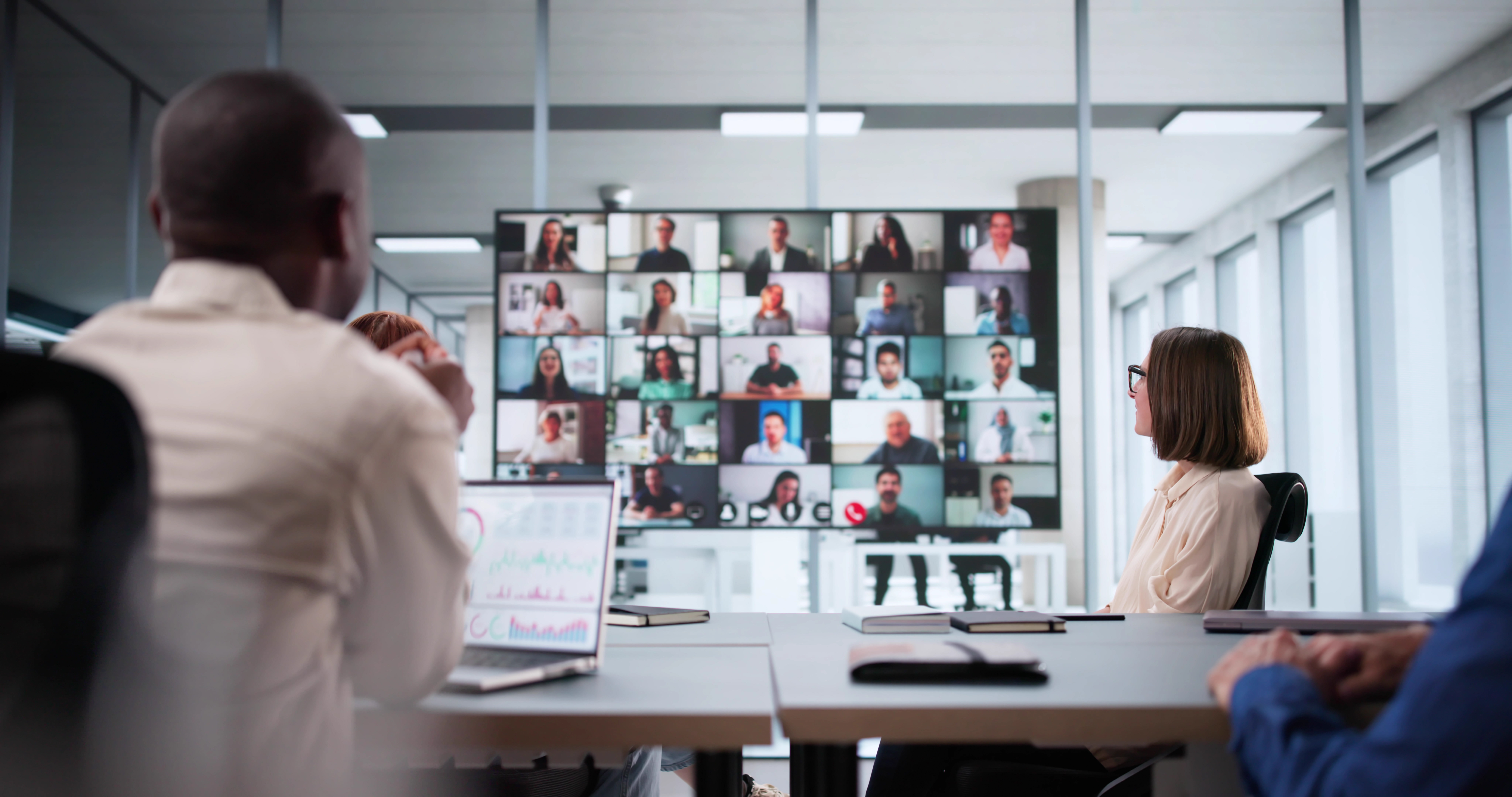 Team collaborating remotely via video conference using cloud technology